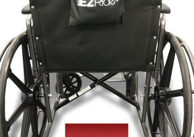 An image of the back of a manual wheelchair with the EZRide charger carry bag hanging across the back handles and the EZRide logo below