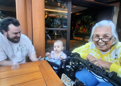 An image of EZRide owner Ms. Maya out and about in her wheelchair, with her family